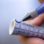 Rhian Malin decorating a mandala bottle in her workshop 2019